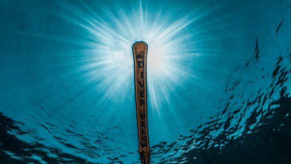 divers surface marker buoy inflated at the surface with sun rays maldives
