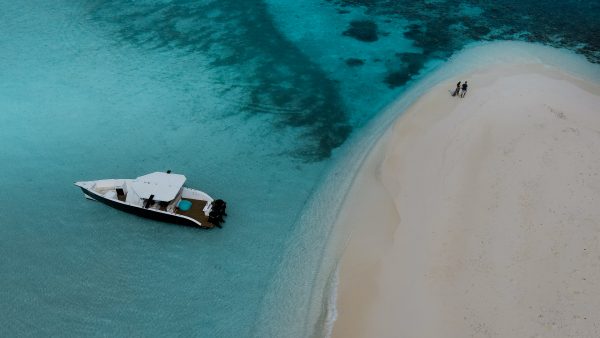 Dive Butler Maldives Couple on Sandbank with Luxury Speedboat