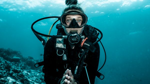 scuba dive instructor in the crystal-clear waters of the Maldives, representing private scuba instruction