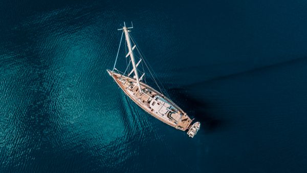 aerial view of a yacht in the calm blue ocean