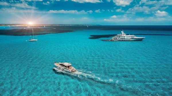 aerial view of superyachts on a calm blue ocean in the Caribbean
