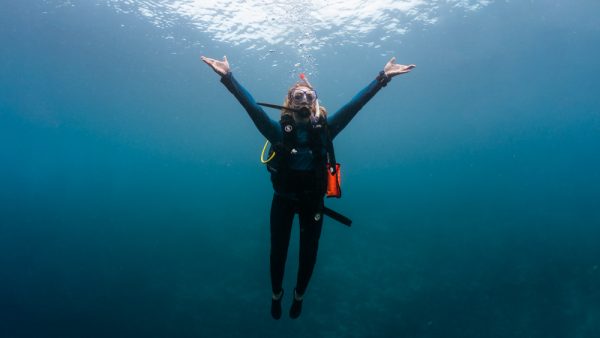 sophie morgan underwater in scuba diving equipment with arms outstretched