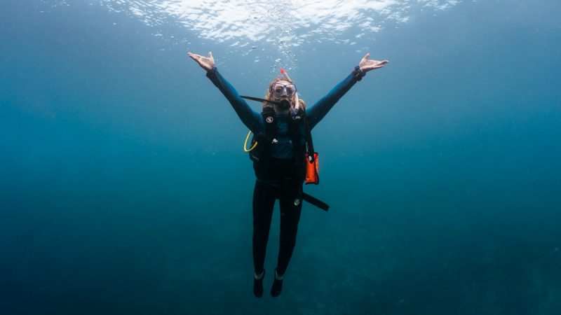 sophie morgan underwater in scuba diving equipment with arms outstretched