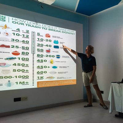 dive butler blue wave ifuru team member giving a presentation on responsible ocean practices